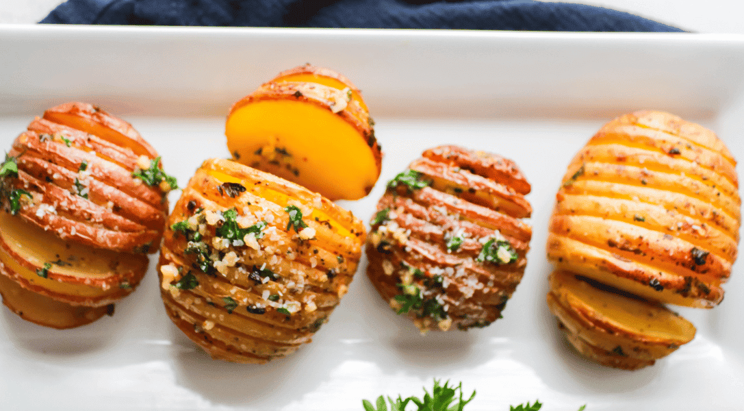 Hasselback Potatoes on white plate