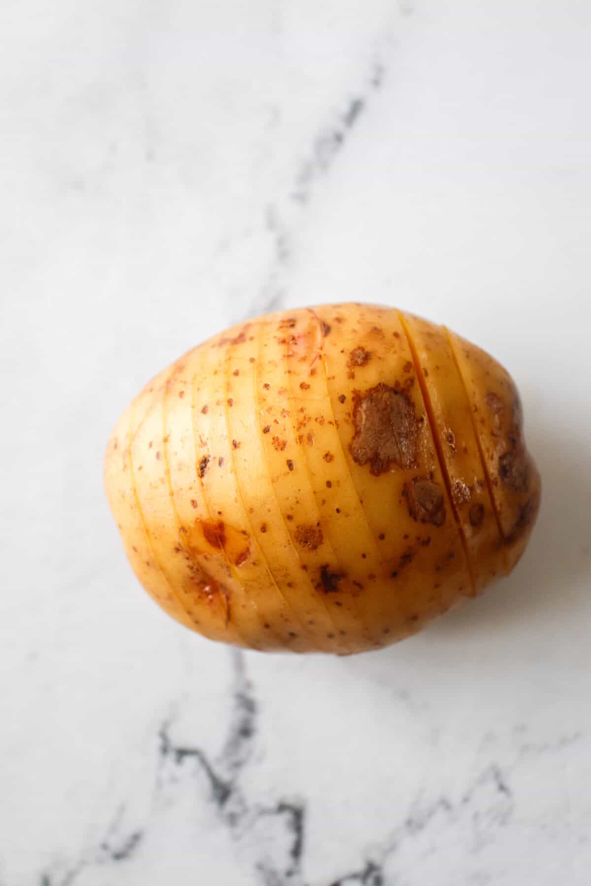 potato that's been sliced for a hasselback potato
