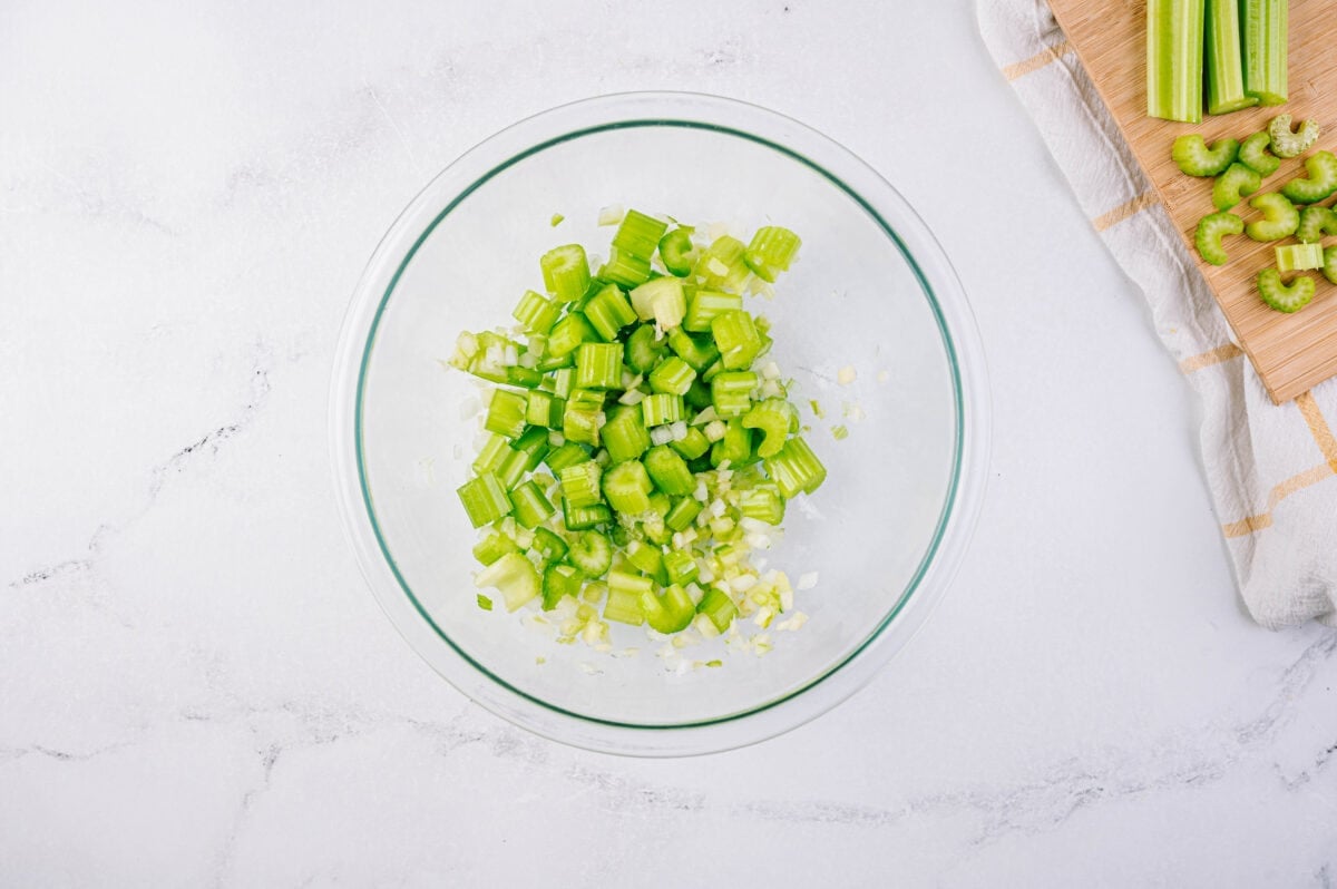 celery and onions diced in glass bowl