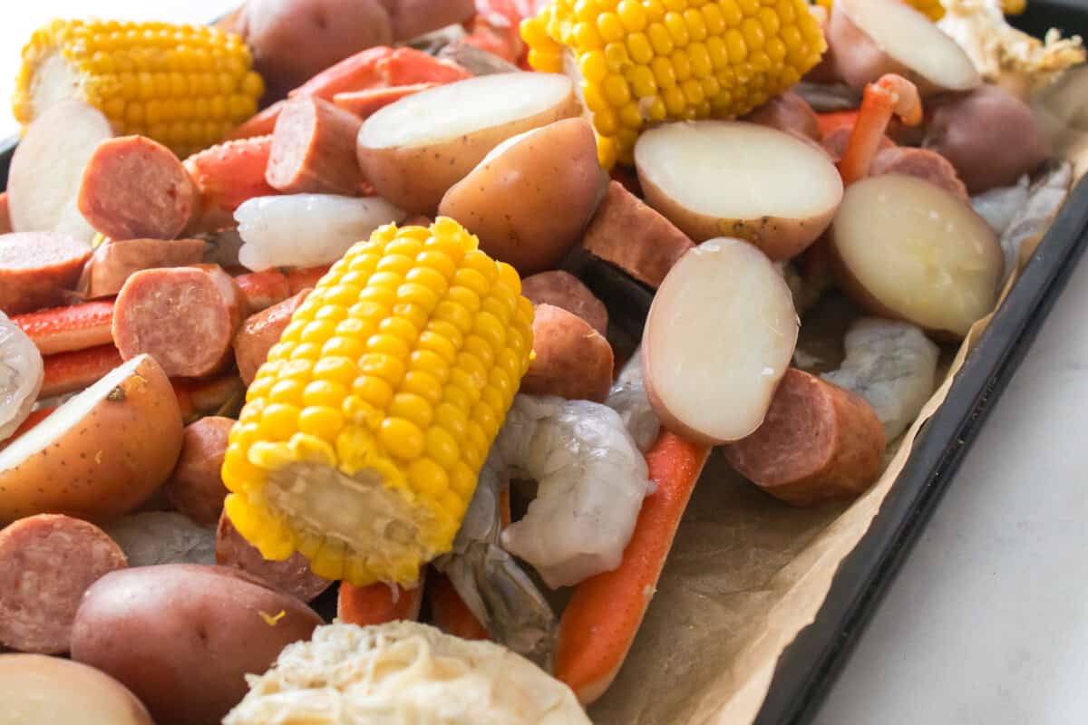 close up shot of ingredients for sea food boil on sheet pan