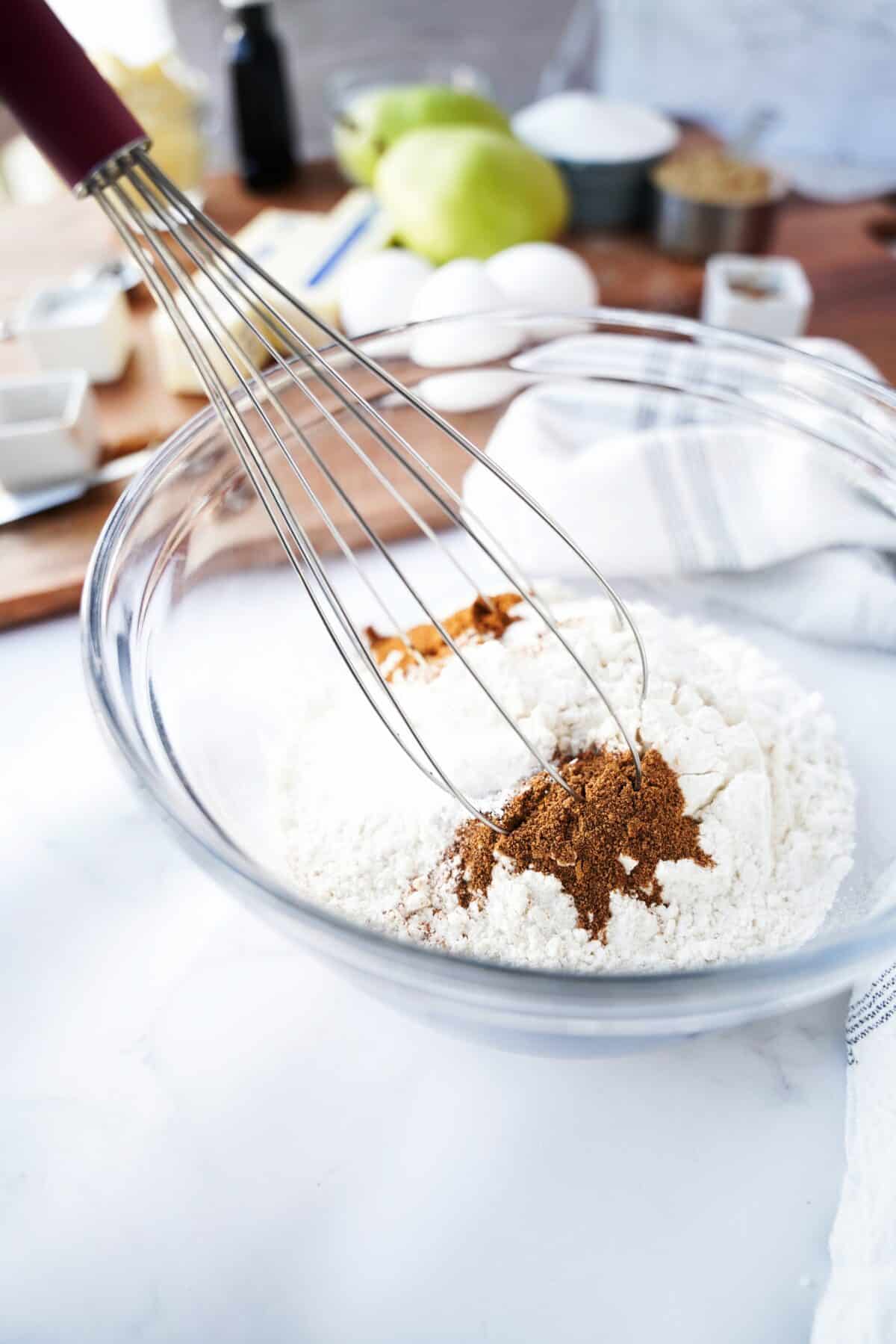 glass bowl with baking agents being whisked together