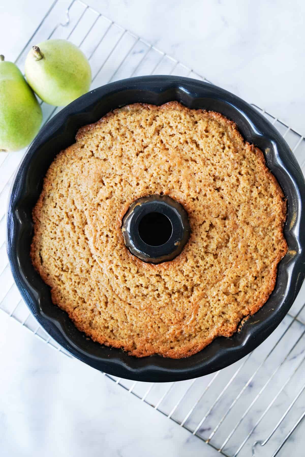 pear bundt cake cooling on baking rack after being baked