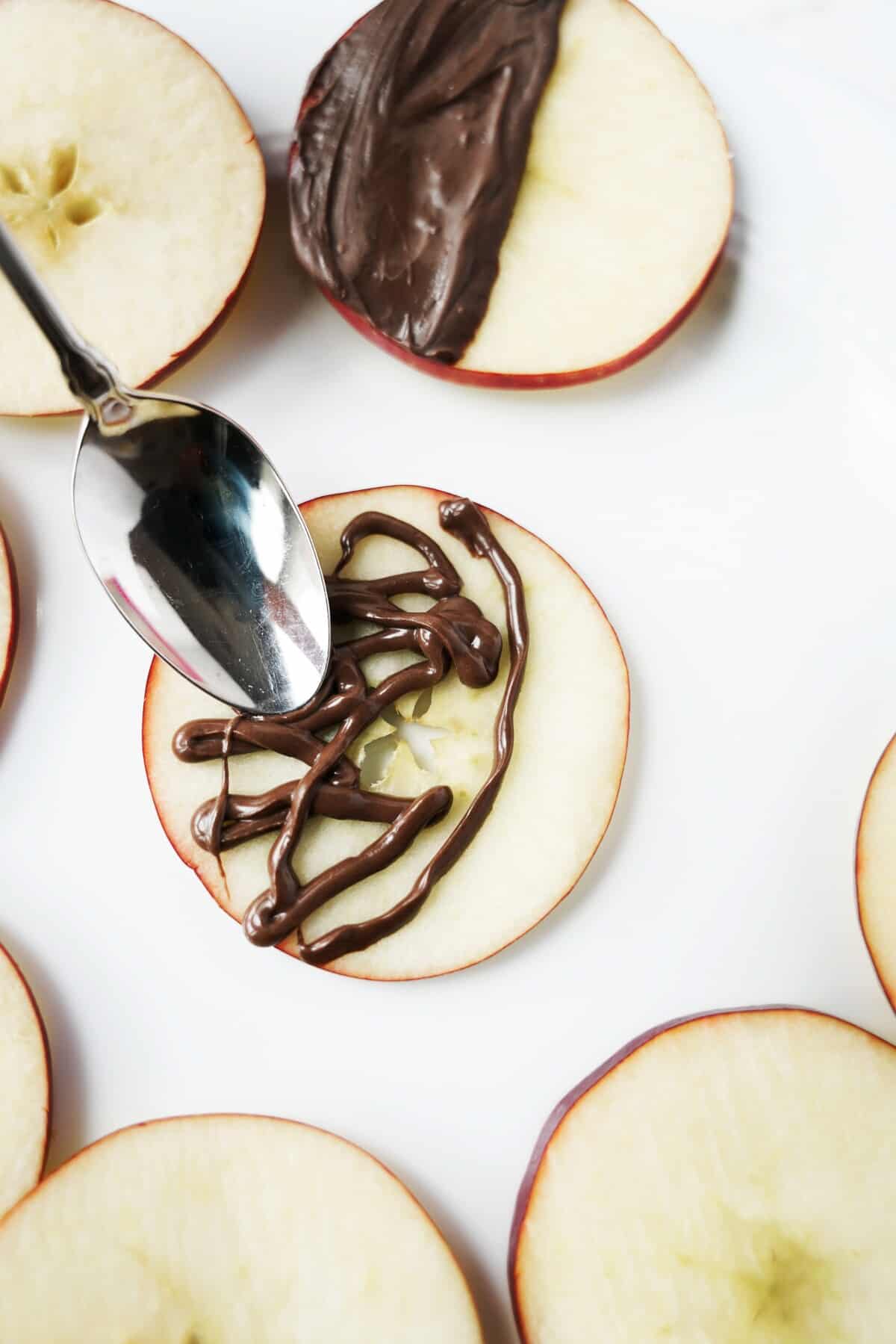 Use a spoon to evenly spread the piped, melted chocolate.