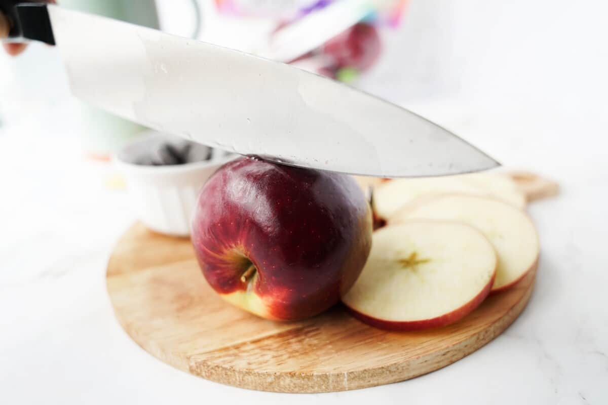 A knife slicing an apple.