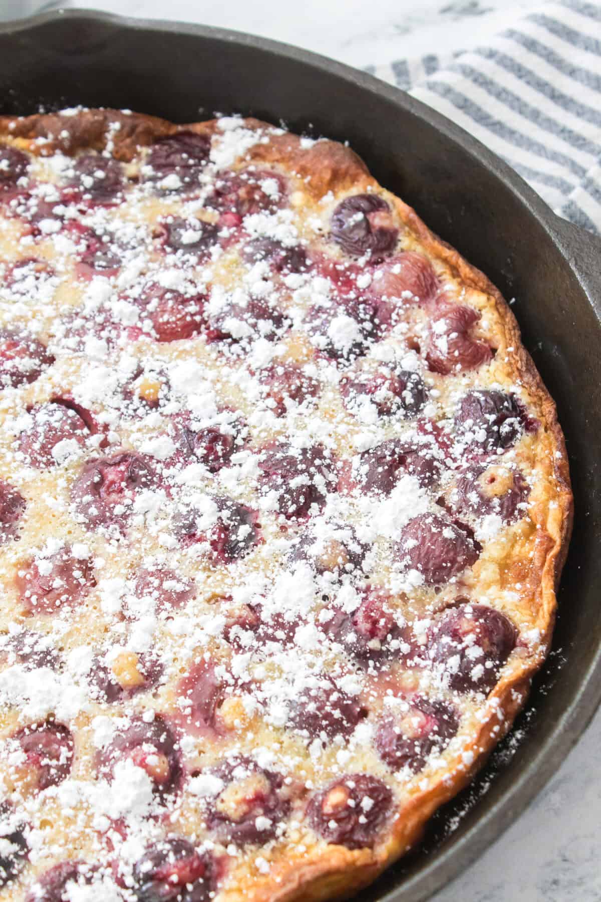 close up vertical shot of baked cherry clafoutis