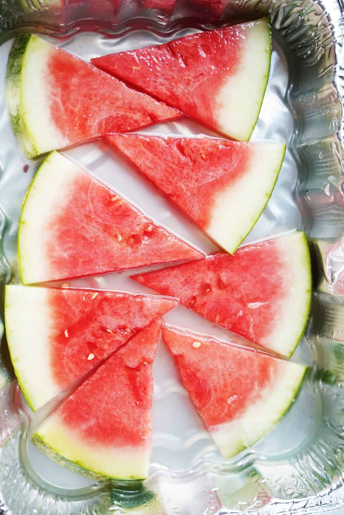 watermelon slices soaking in tequila