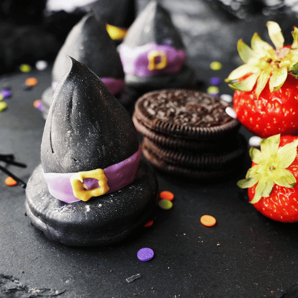 Strawberry Witch Hats on plate with strawberries and Oreos