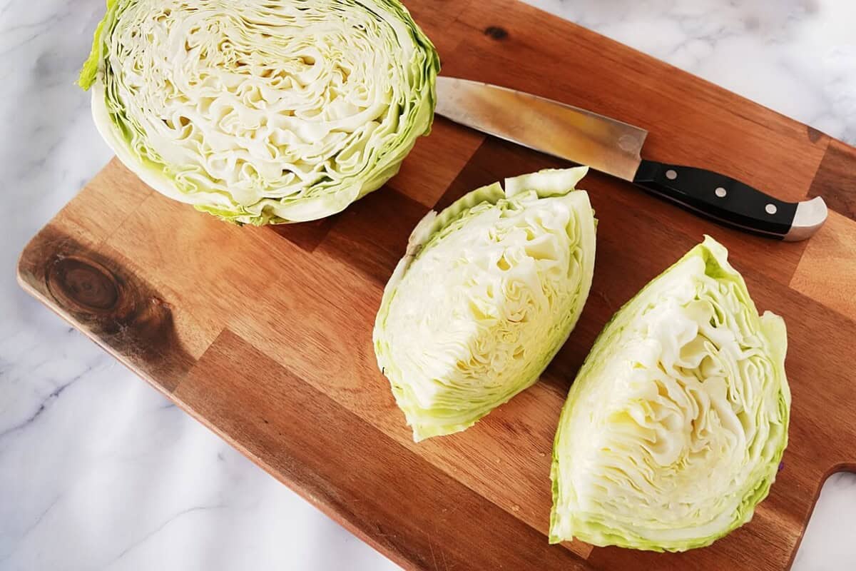 Cut Cabbage wedges on cutting board