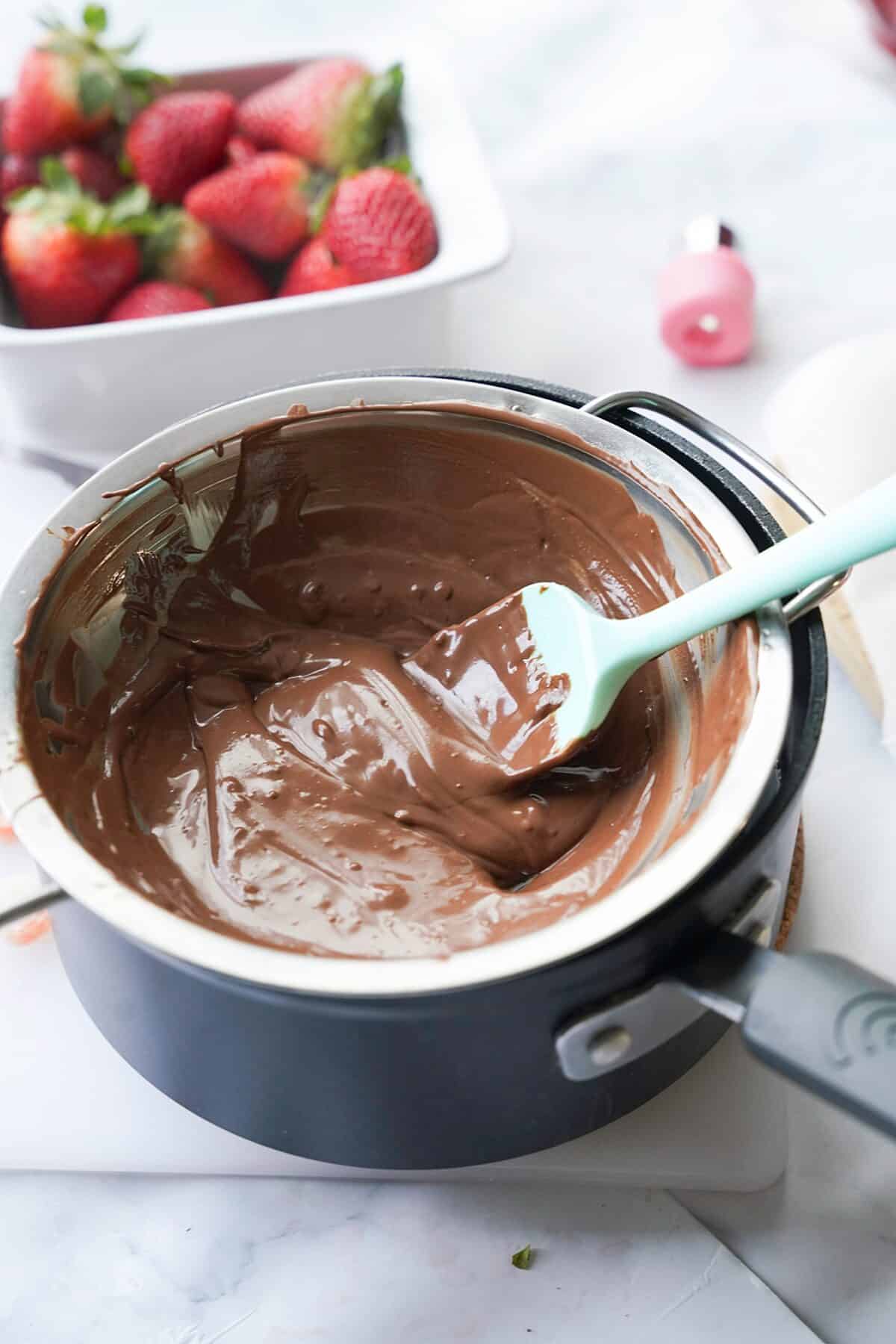 chocolate melting in saucepan with spatula