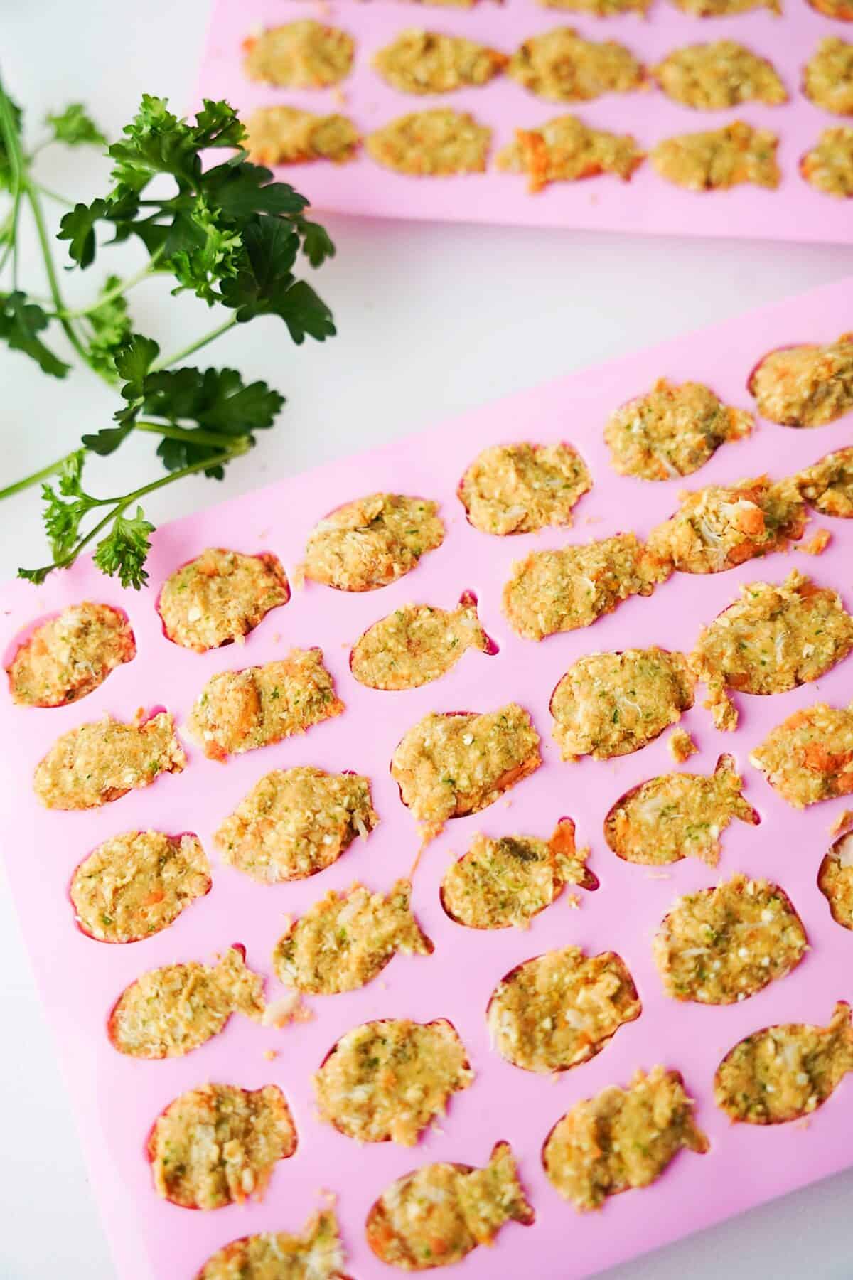 pink fish molds with sweet potato and tuna mixture after freezing