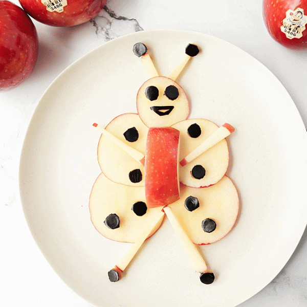 Honey Bee on plate made from apple slices and eggplant