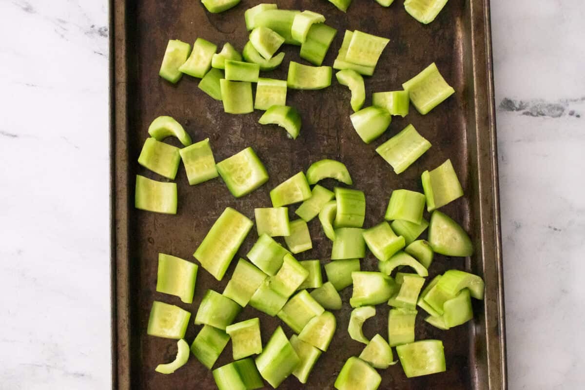 peeled and de-seeded cucumber chunks on baking sheet prior to freezing