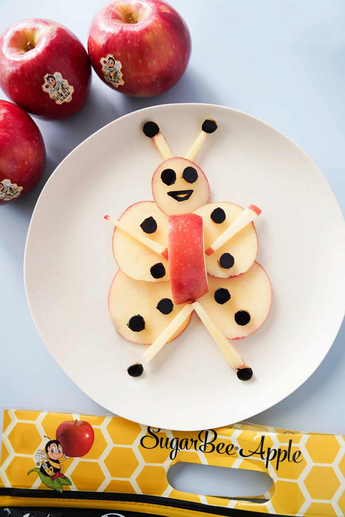 Apple slices made in the shape of a honey bee snack idea