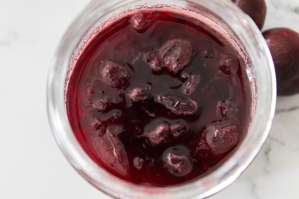 overhead shot of cherry vanilla syrup in mason jar