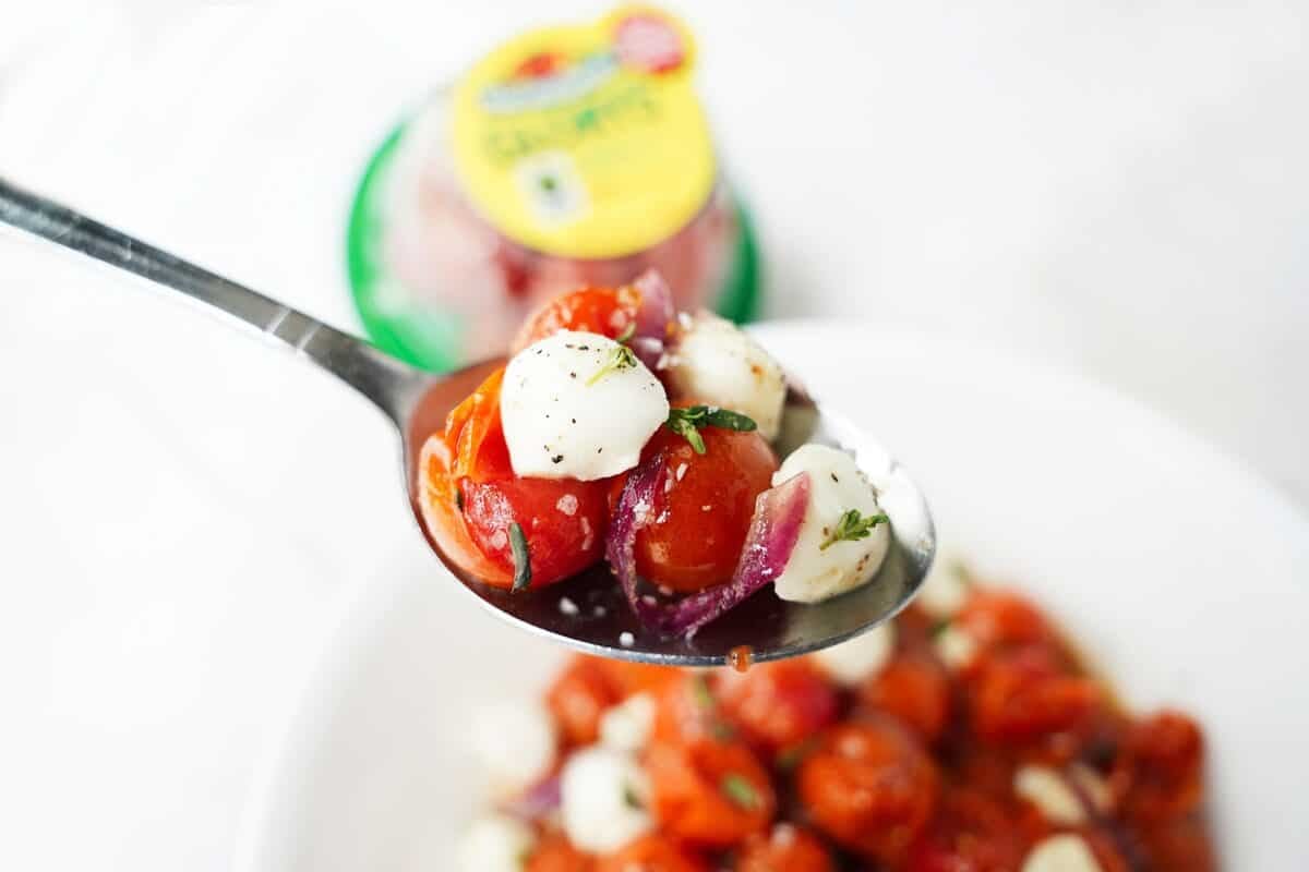 spoonful of honey roasted tomatoes and onions with mozzarella pearls