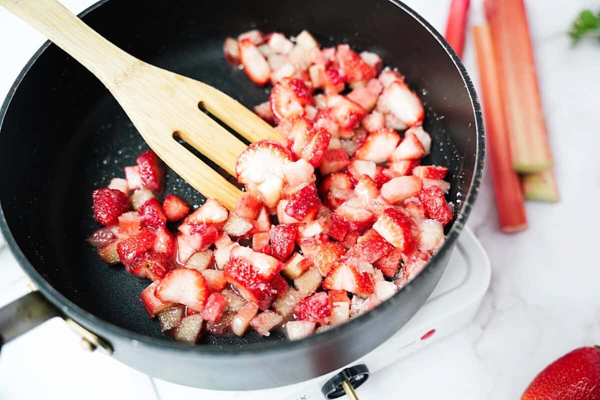 strawberries, rhubarb diced in skillet with sugar, lemon zest and honey before bringing to a boil