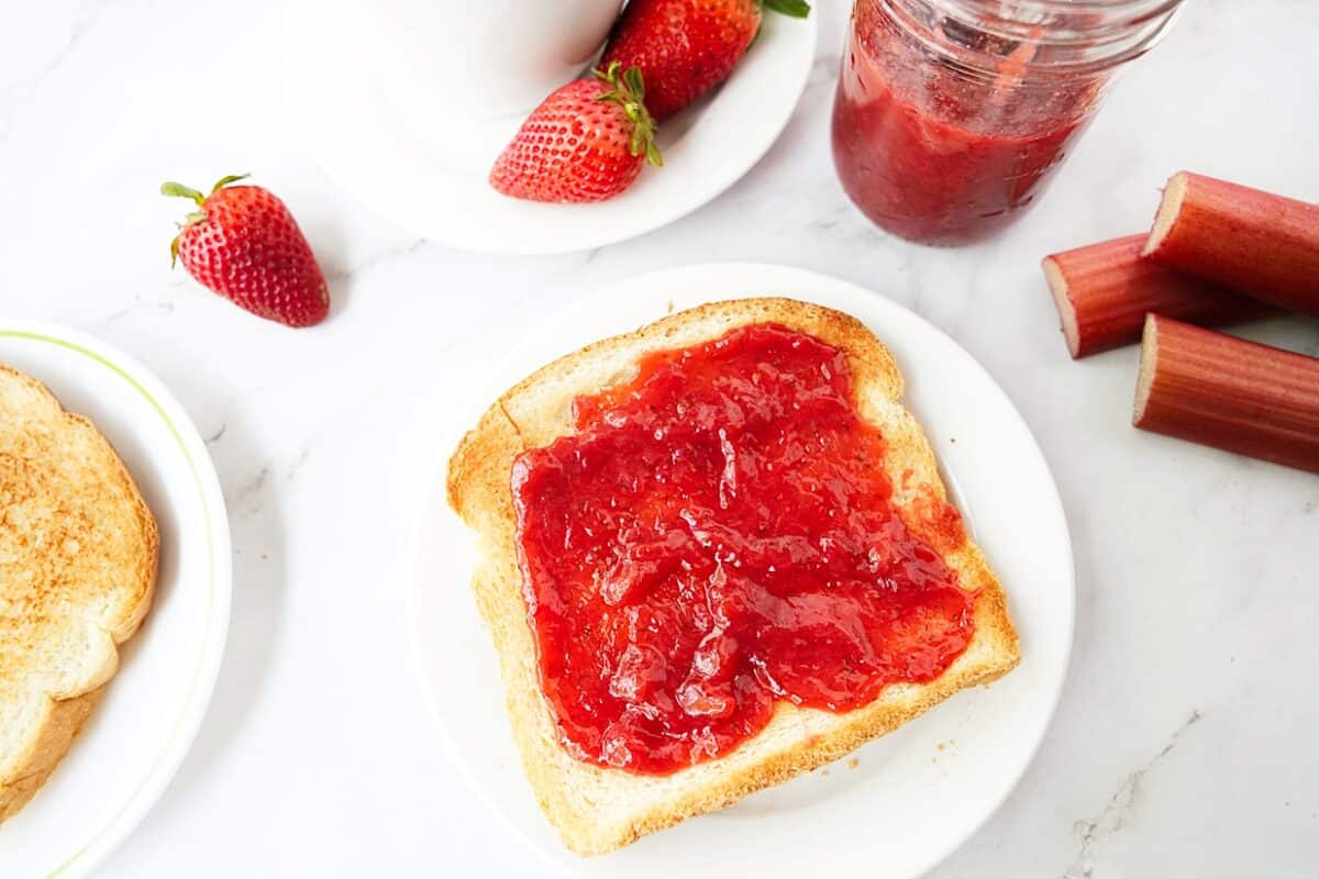 overhead shot of strawberry rhubarb jam slathered on toast