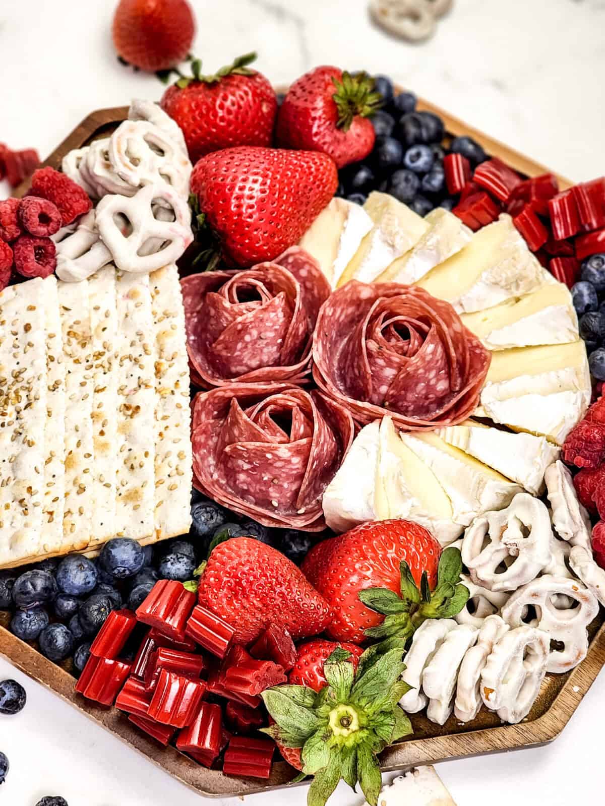 close up shot of 4th of july charcuterie board focused on salami that looks like roses
