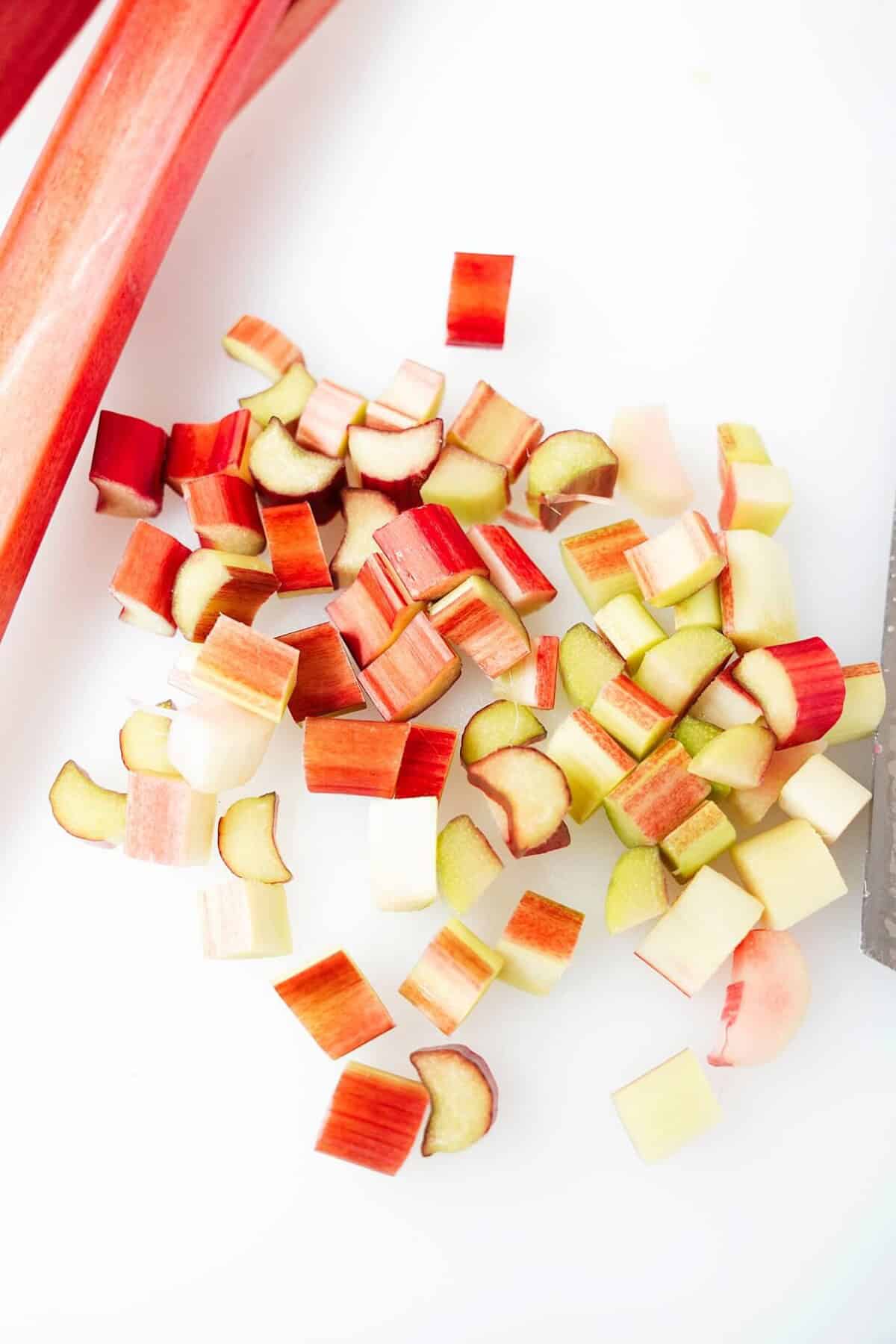 Vertical images of rhubarb diced on cutting board