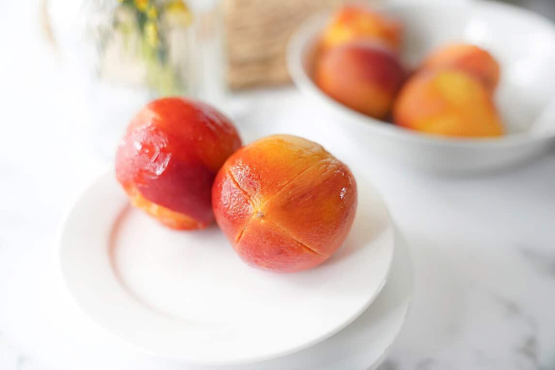 Blanched peaches on a white plate