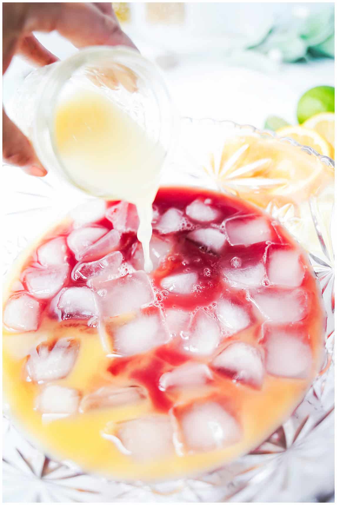 Add the citrus and pomegranate juices to a punch bowl with ice.