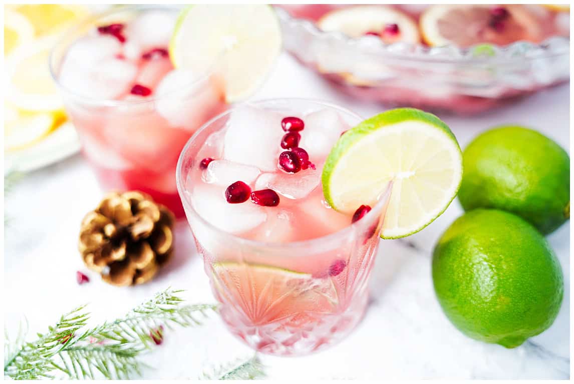 Sparkling citrus punch with a lime and pomegranate aril garnish