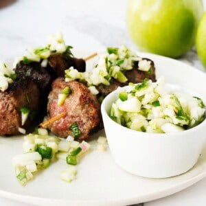 Steak skewers served with apple chimichurri on top
