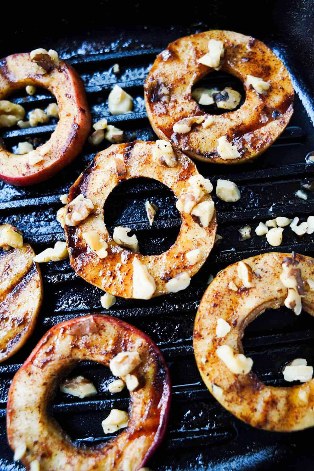 Grilled honey bourbon apples topped with walnuts