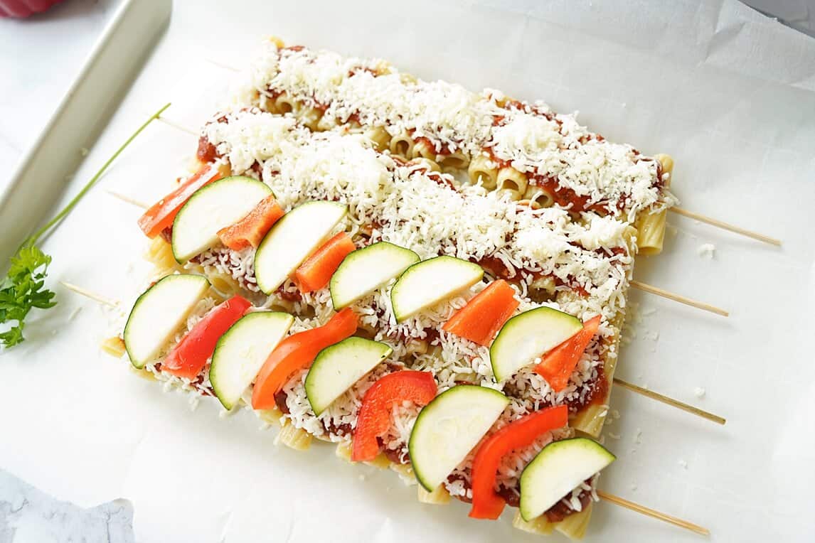 Layering veggies on Veggie Pasta Kabobs