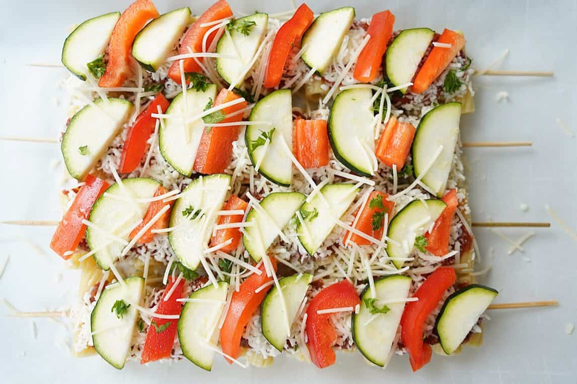 Cheese on top of finished Veggie Pasta Kabobs