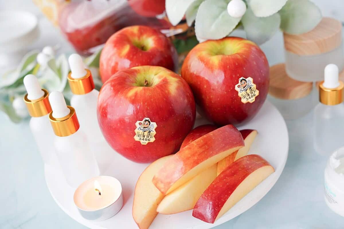 SugarBee apple on plate with beauty bottles