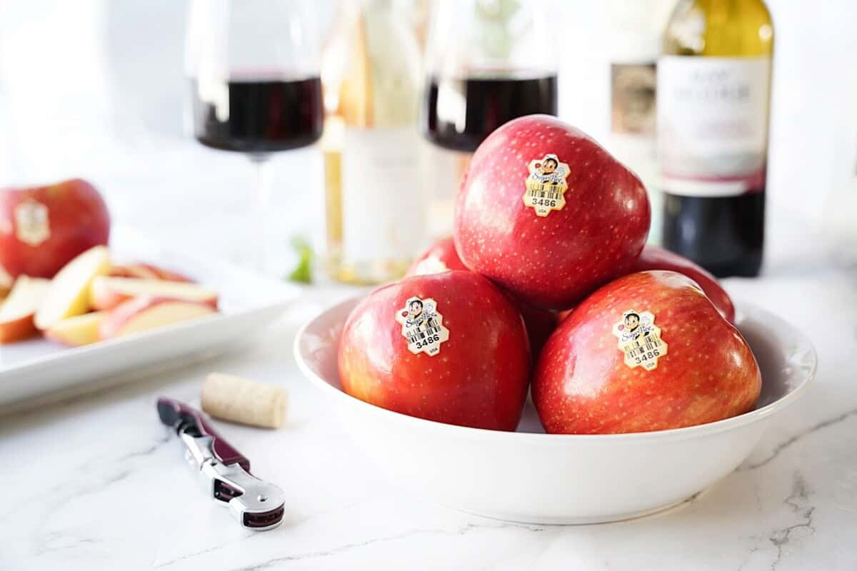 SugarBee apples in bowl with wine glasses