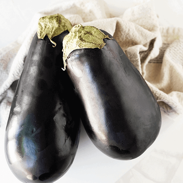 2 full eggplants on kitchen counter