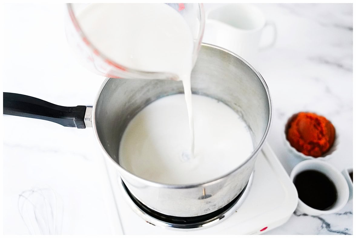 milk being poured into stainless sauce pan