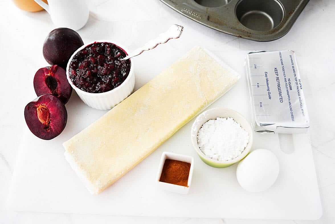 ingredients to make sugar plum danishes: plum jelly, puff pastry, cinnamon, powdered sugar, egg and cream cheese