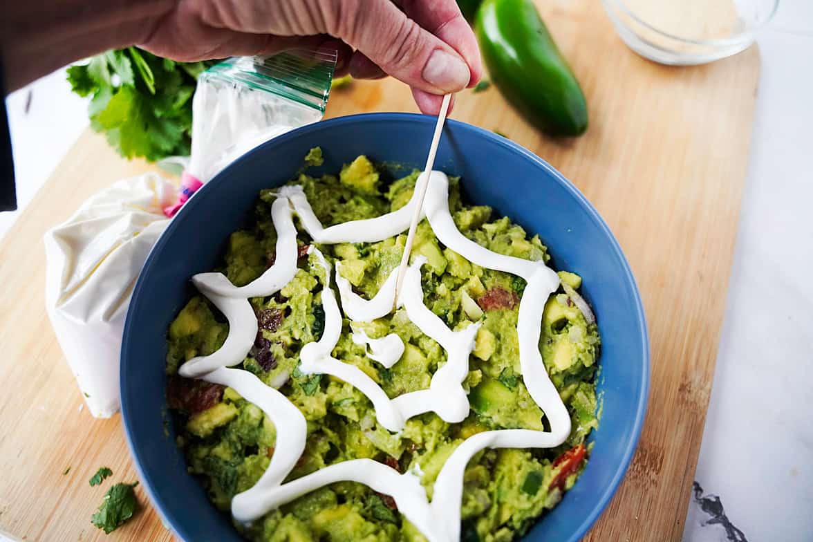 Using a toothpick to create the "web" with the sour cream concentric circles