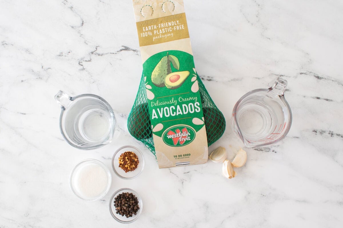 ingredients for pickled avocados: bag of westfalia fruit avocados, water, sugar, peppercorn, red pepper flakes, vinegar and 3 whole garlic cloves