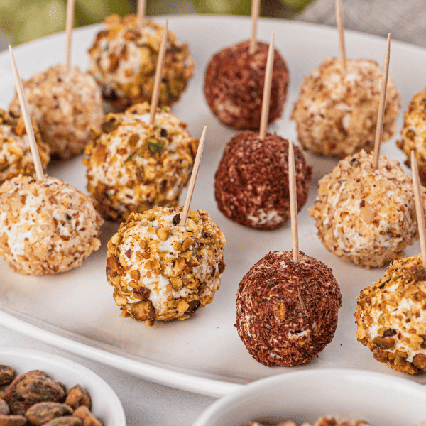 Savory Grape Truffles on white plate with toothpicks