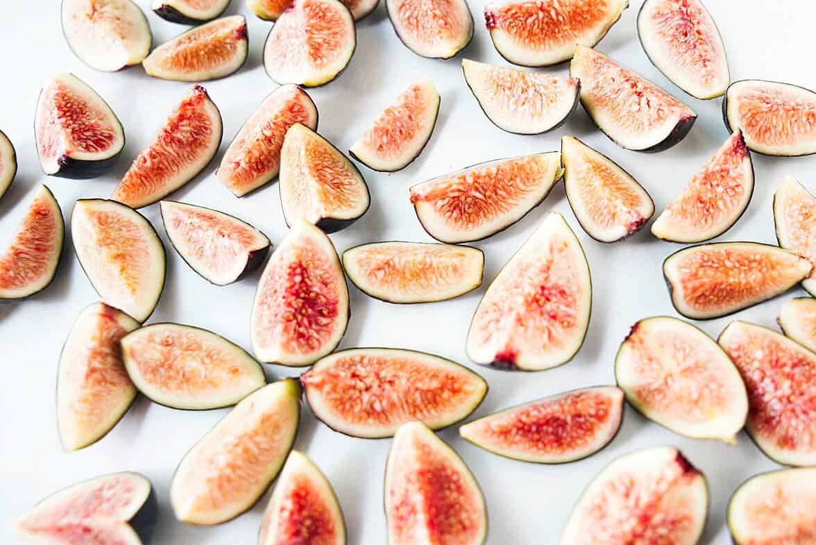 Close up of quartered figs on a sheet pan