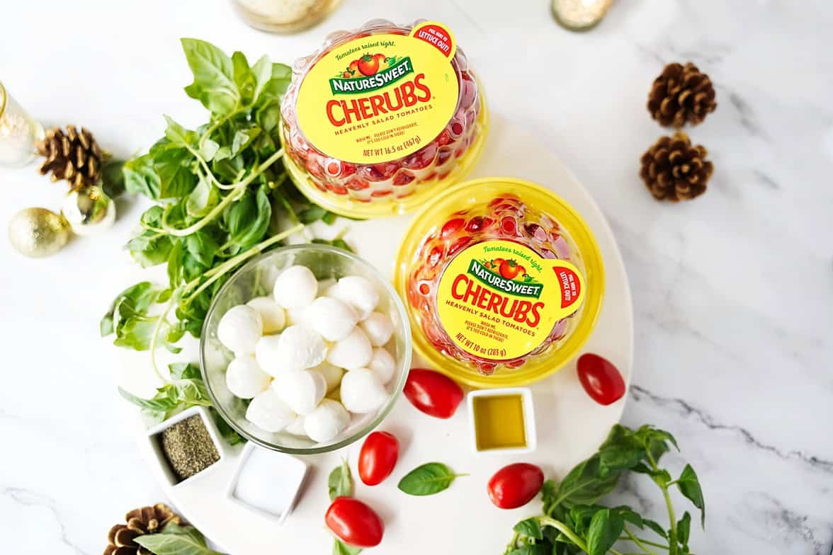 Basil, tomatoes, mozzarella pearls, salt, pepper, and olive oil