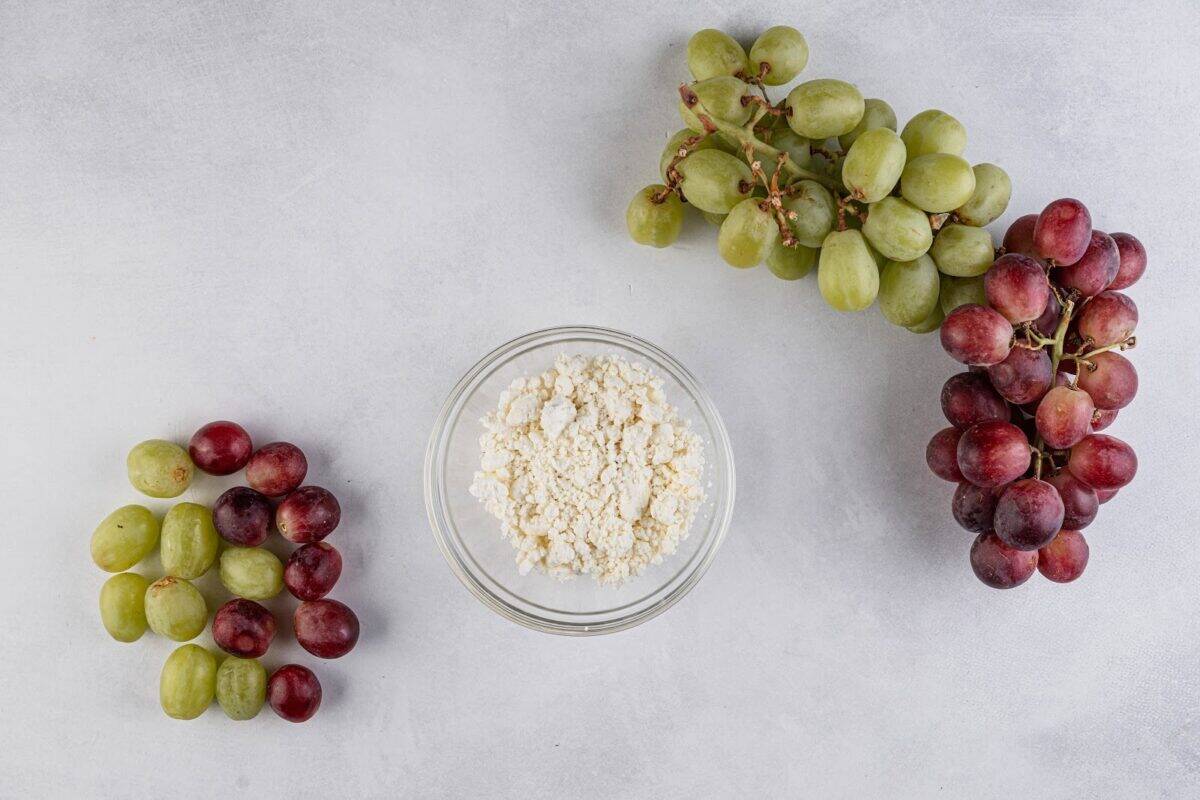 Rinsed grapes with a bowl of goat cheese