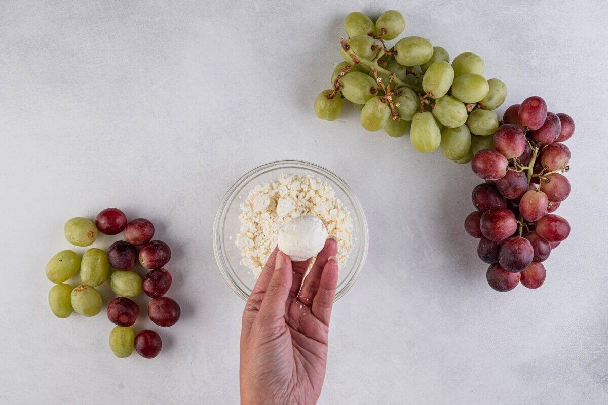Coat the grape with goat cheese.