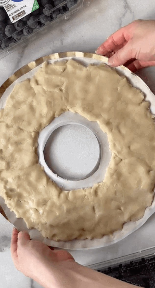 Spreading cookie dough on pan in wreath shape