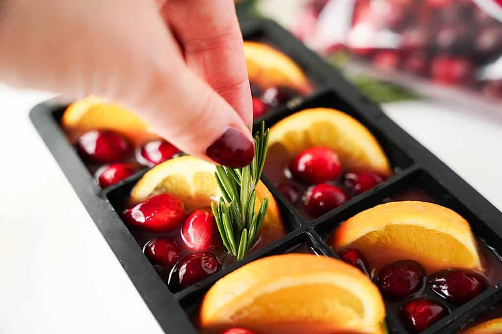 adding rosemary to the ice cube molds