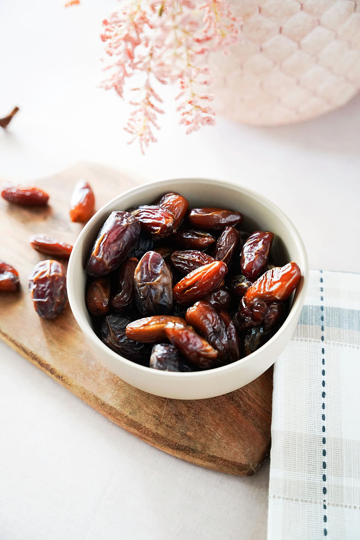 Vertical image of dates in a white bowl