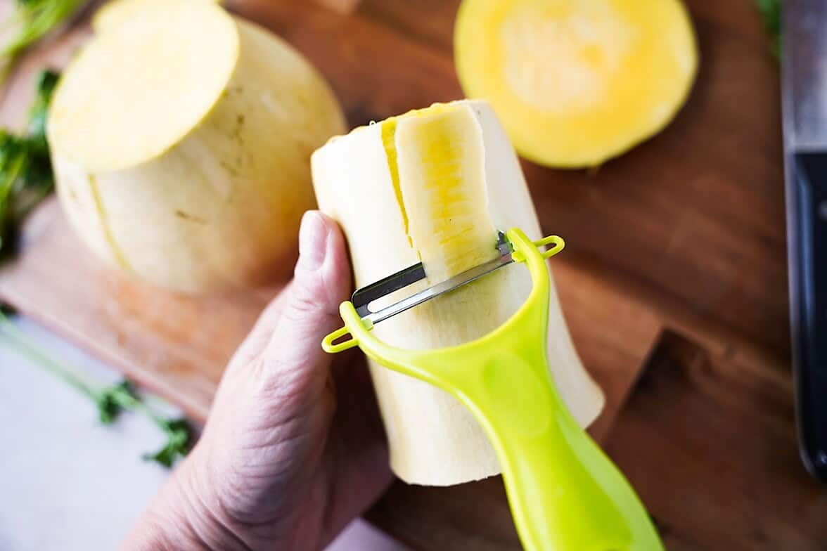 peeling the skin of a butternut squash