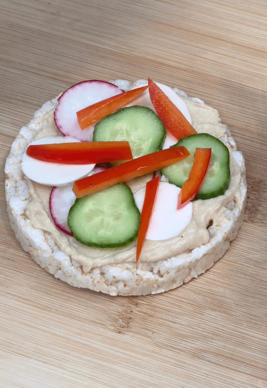 Close up of veggies on rice cake pizza
