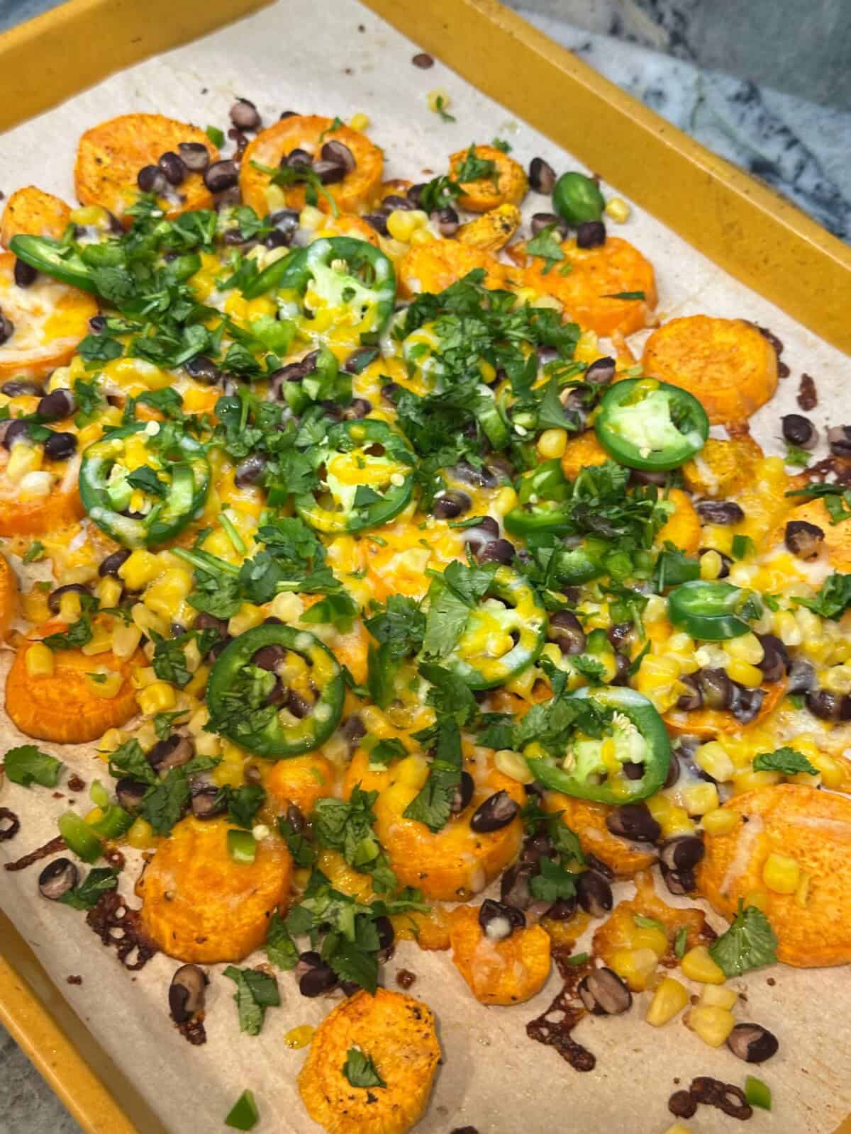 fully loaded sweet potato nachos on sheet pan