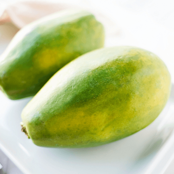Two papayas on a white plate