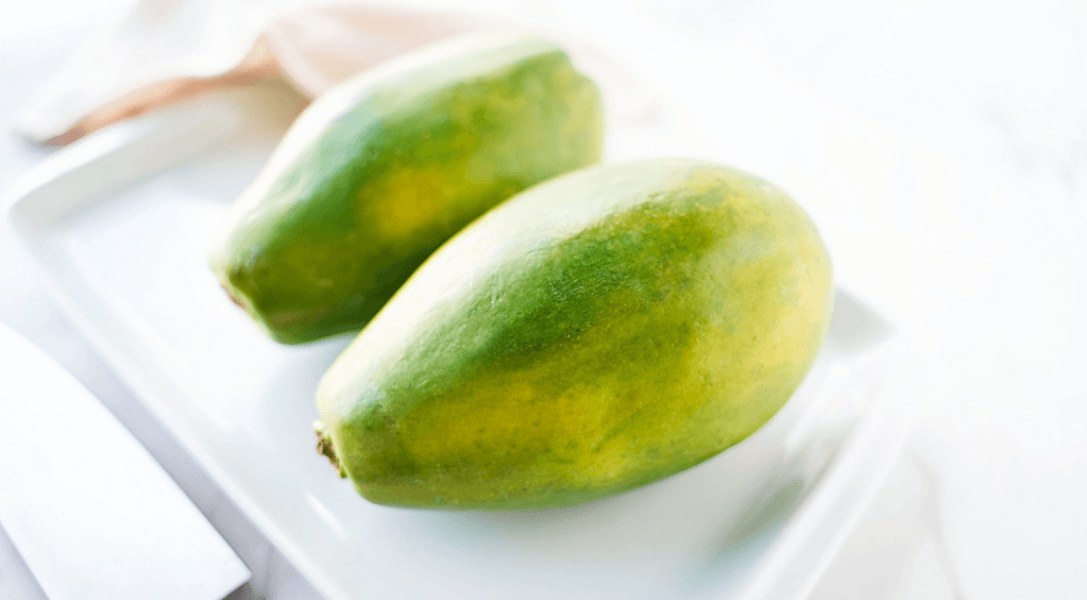 Two papayas on a white plate